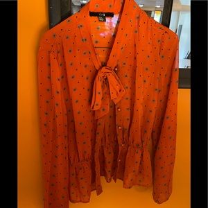 Orange bow blouse with brown and blue polka dots